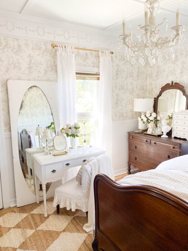 Cottage style bedroom with antique furniture and a small bedroom vanity