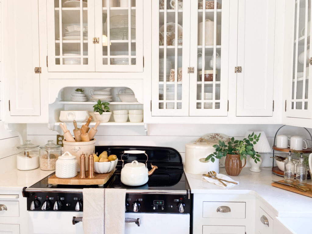 Cottage kitchen with vintage style stove and antique white and brown transferware dishes