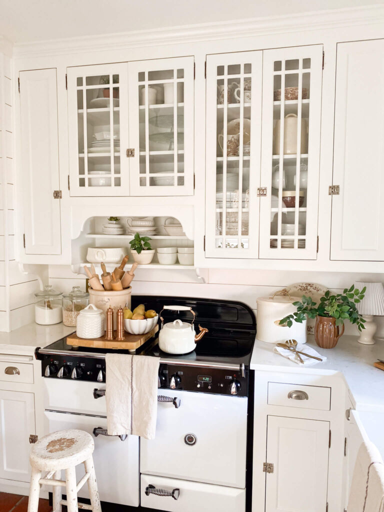 Image of a white cottage kitchen with vintage inspired cabinetry and AGA vintage inspired stove