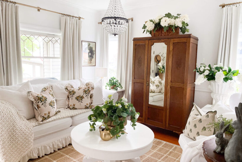Image of a small cottage living room with slipcovered couch and chandelier