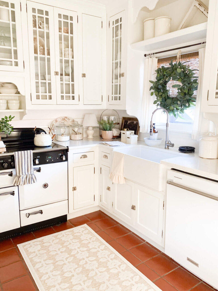 Cottage Kitchen with farm sink, vintage inspired AGA stove and a floral runner