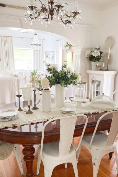 Spring dining room with antique dining table, white metal chippy paint chairs and antique dishes