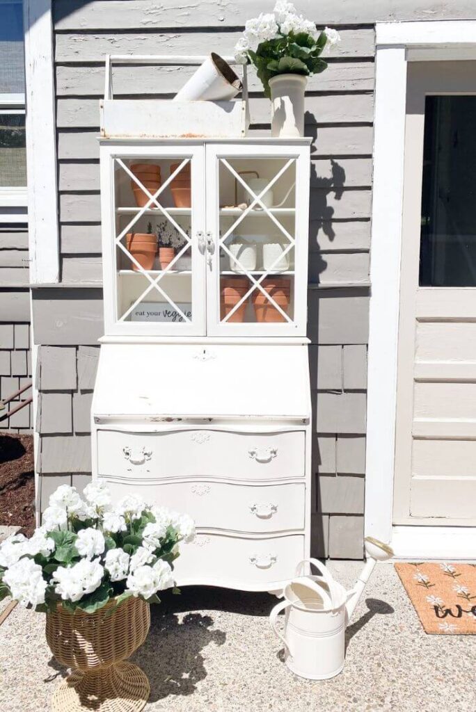 Patio refresh with a vintage desk and terra cotta pots.