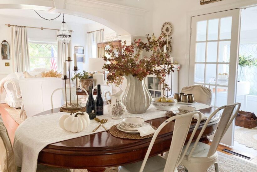 Formal dining room styled for fall with fall stems and brown transferware everyday dishes