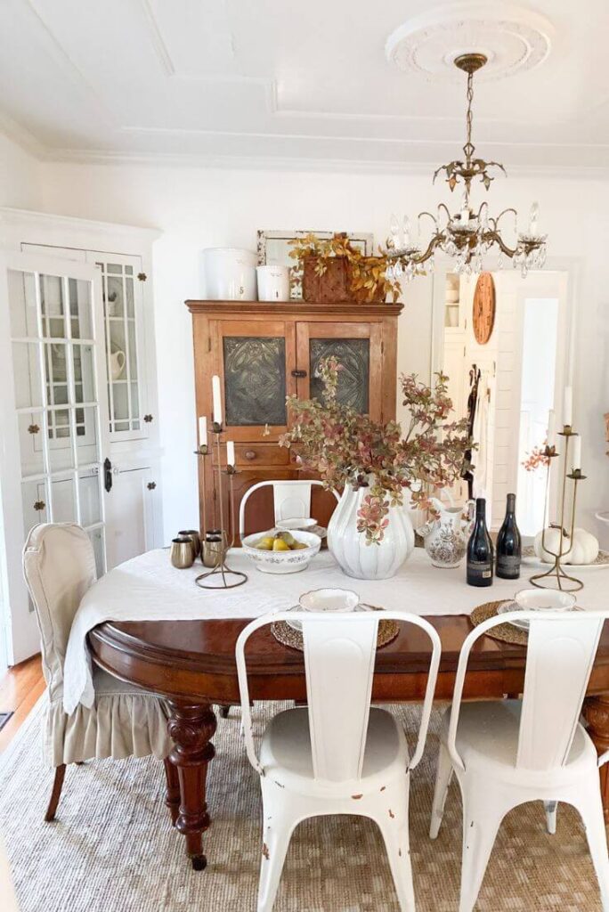 Fall dining room decor with fall stems and brown floral dishes