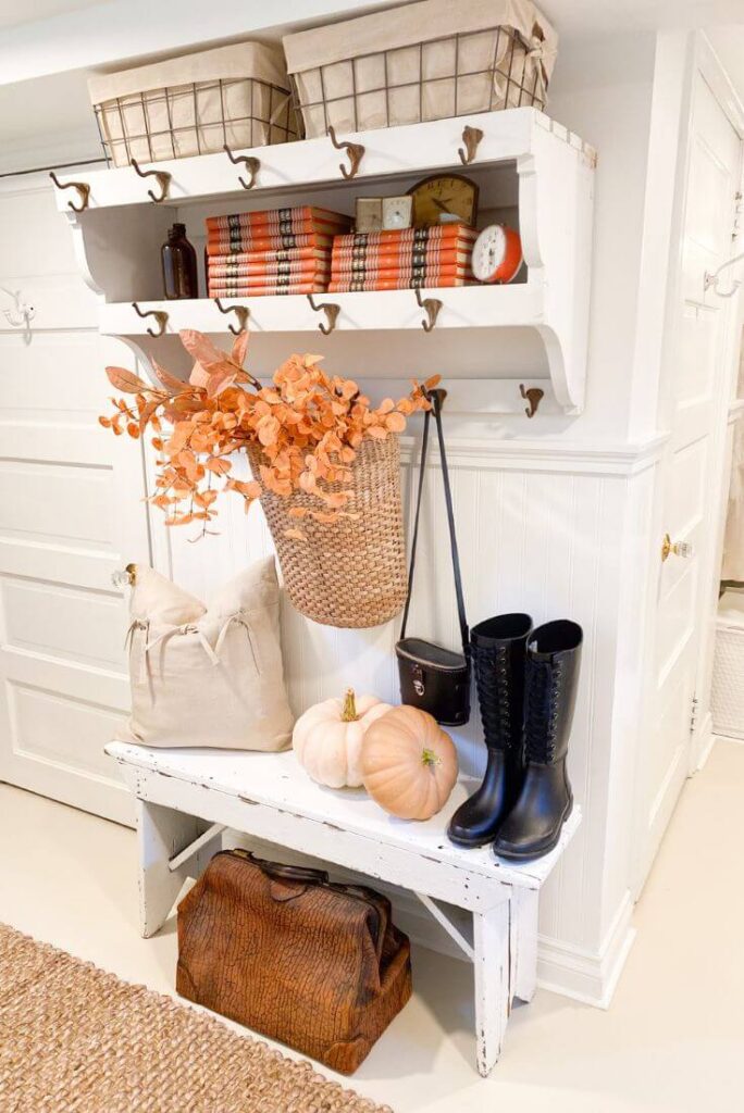 Vintage books, barn boots, and nuetral pumpkins for a farmhouse fall look