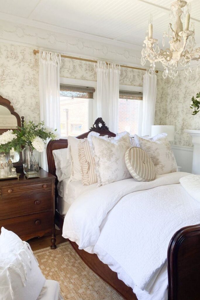 Ruffled striped pillows, cabbage rose pillows and a ruffled light quilt make a perfect summer bedroom makeover