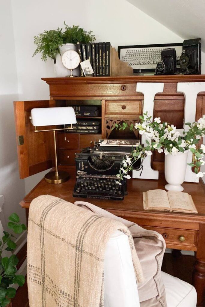 Cottage bedroom vignette with vintage cameras and framed vintage photo