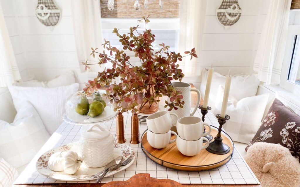 Fall table styled with brown and white transferware and pumpkin mugs