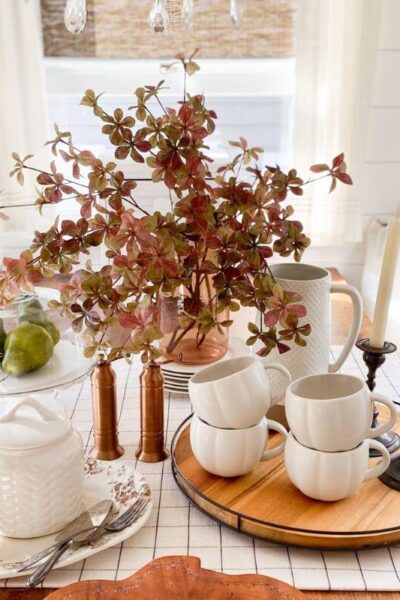 Fall table styled with brown and white transferware and pumpkin mugs