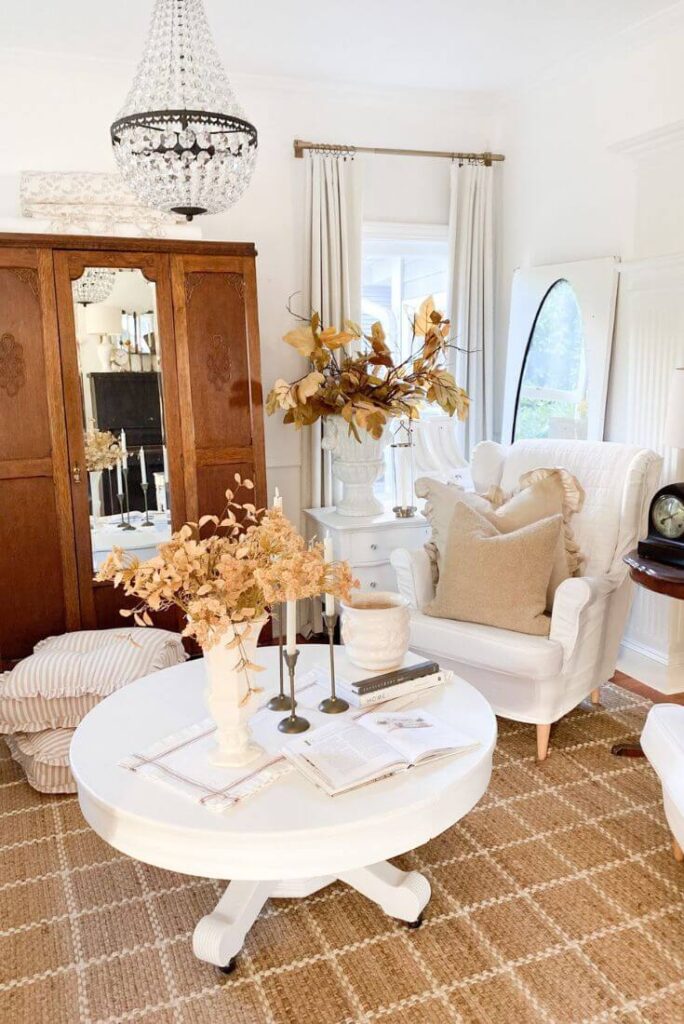 Neutral cottage living room with fall decor accents, cozy textures, and layered whites.