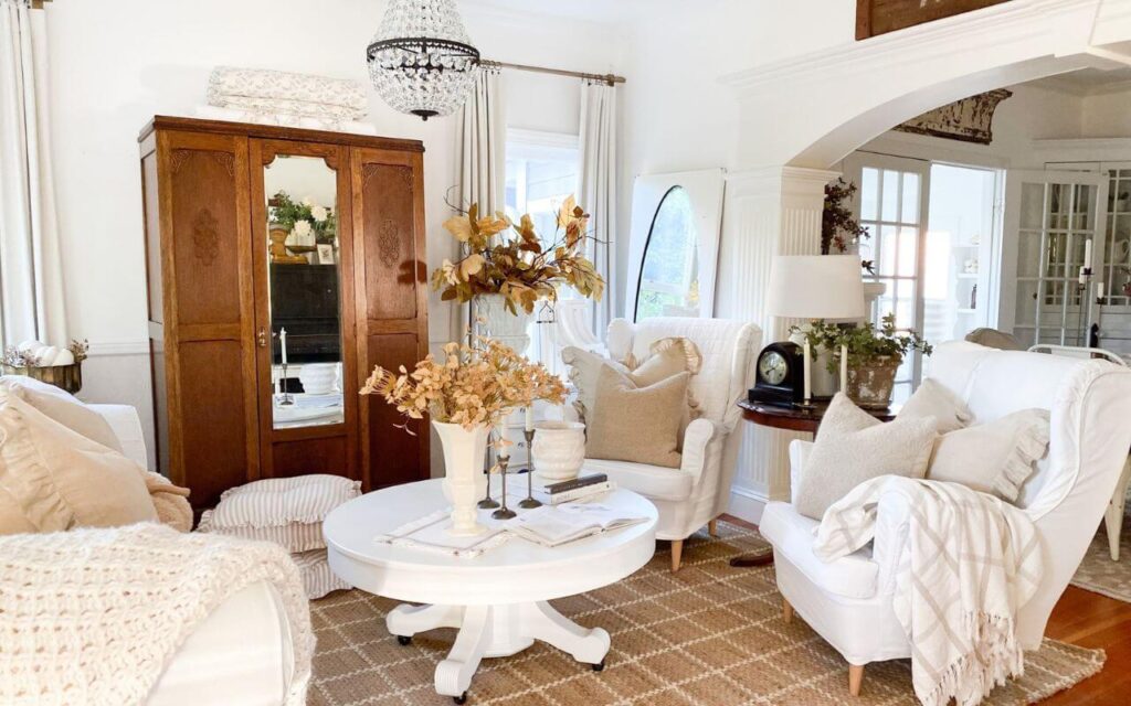Cottage-style living room decorated for fall with soft neutral tones and vintage accents