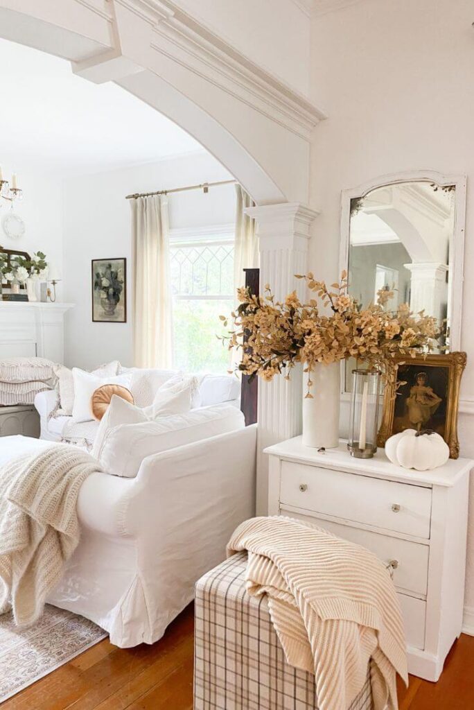 Tiny cottage entry decorated with vintage furniture and simple seasonal touches.