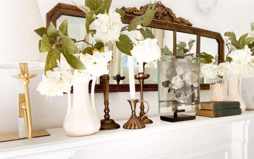 Cottage mantel styled with mix of vintage and modern pieces for year-round charm