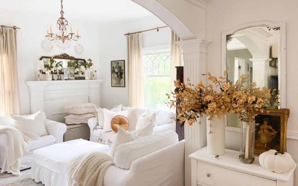 Wide shot of cozy living room with neutral tones and vintage mantel decor