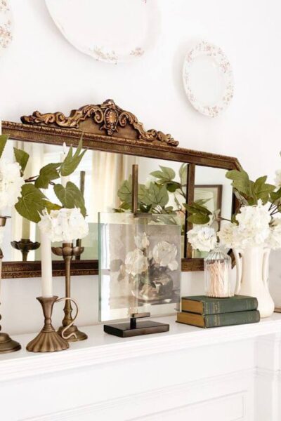 Cozy living room corner with antique mirror and soft neutral textures.