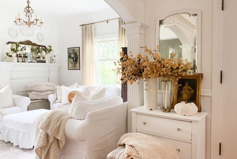 Neutral fall entryway styled with warm autumn branches and antique accents