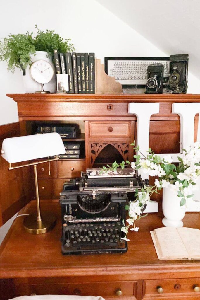 Close-up of old books and vintage family photos on cottage desk