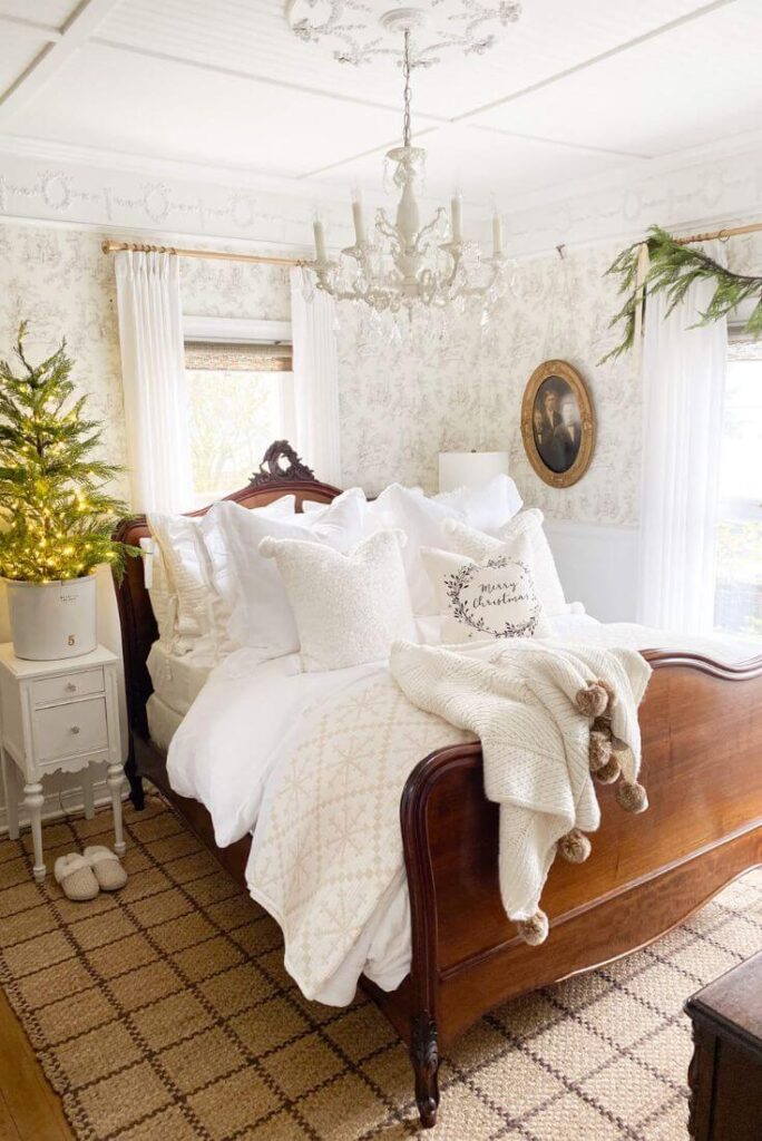Holiday-styled bedroom with jute rug, garland, and white bedding.