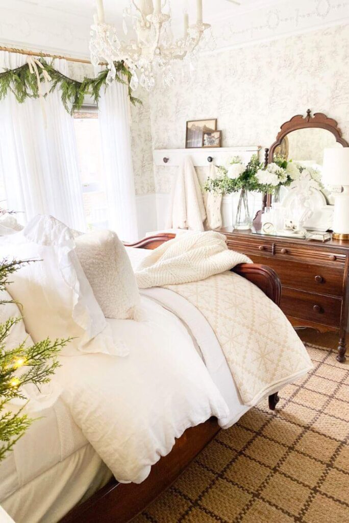 Cottage bedroom with grid jute rug and layered white linens.