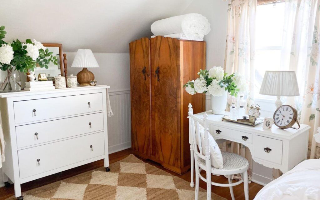 Shabby chic bedroom decor with white antique furniture, ruffled white bedding and rose curtain panels