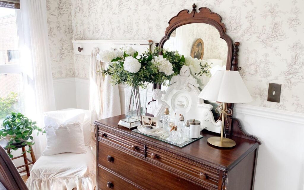 Cottage-style dresser with layered winter decor.