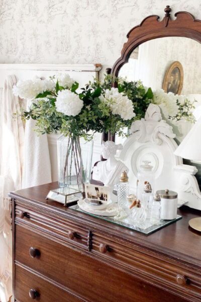 Cottage-style dresser with layered winter decor.