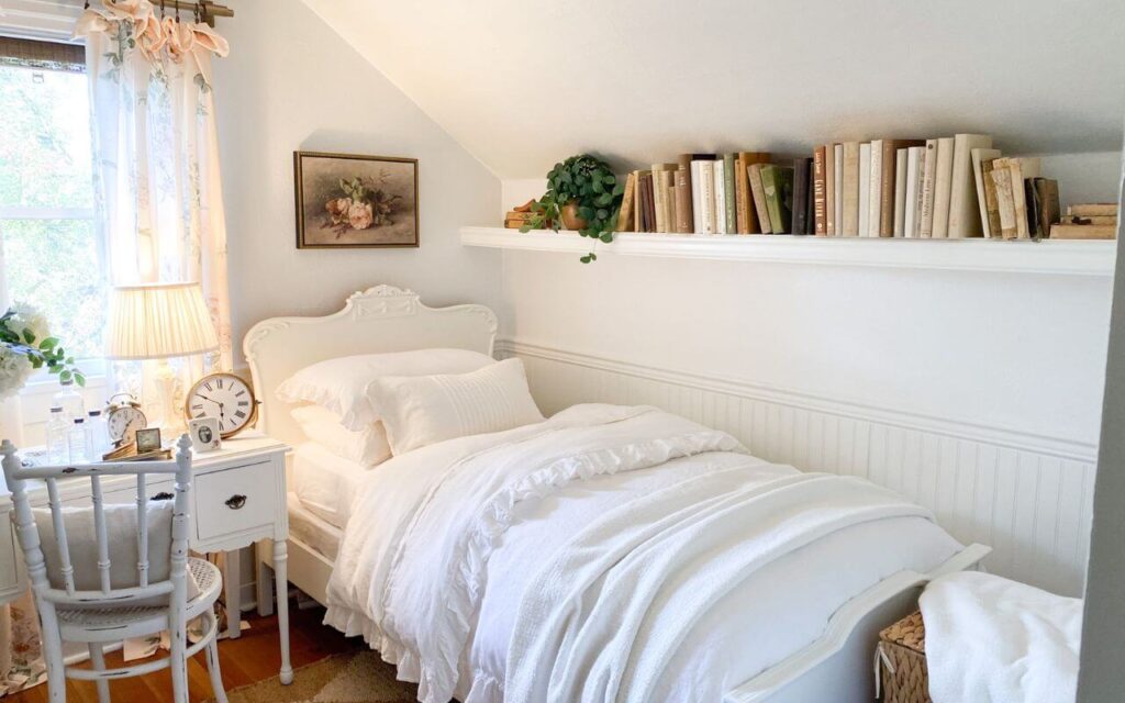 Neutral guest room shelf styled with thrifted books and decor