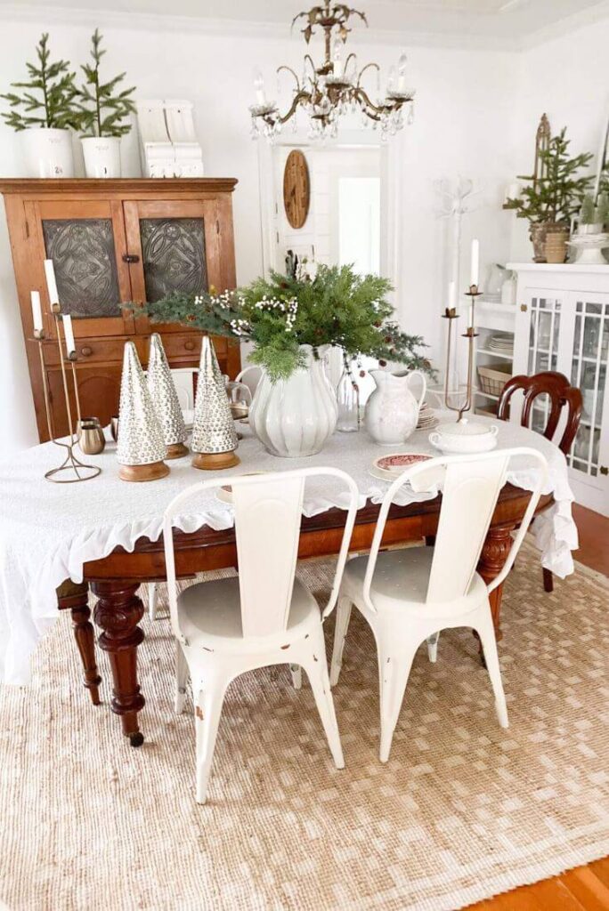 Christmas dining room styled with greenery and a jute rug