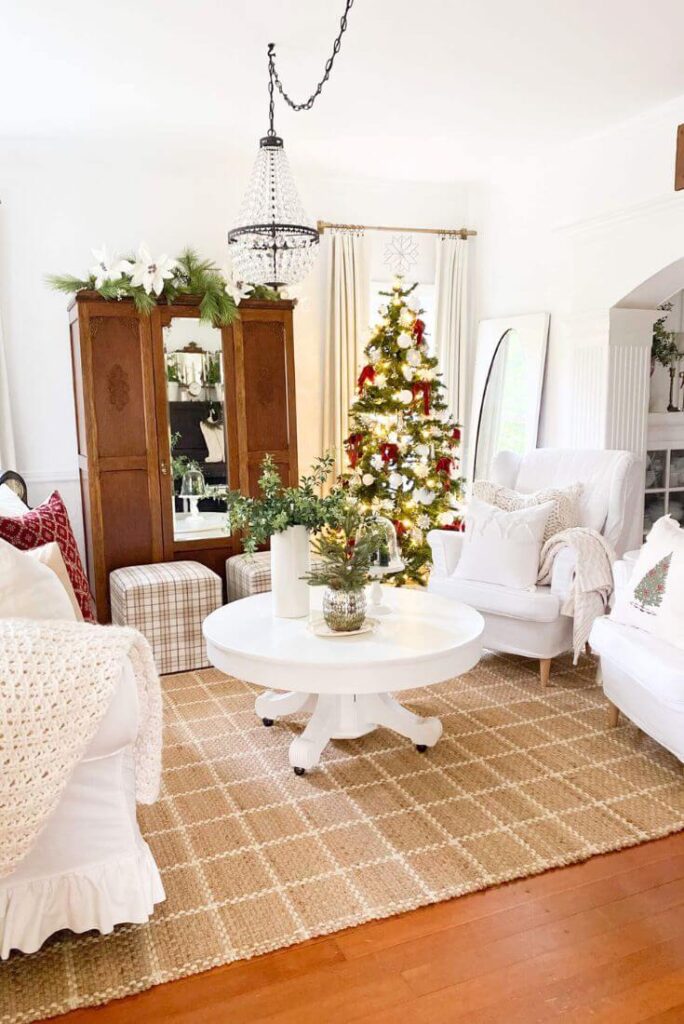 Christmas living room with jute grid rug and decorated tree.