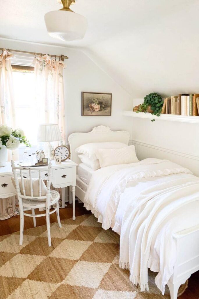 Guest room with white bedding, cottage desk, and diamond jute area rug