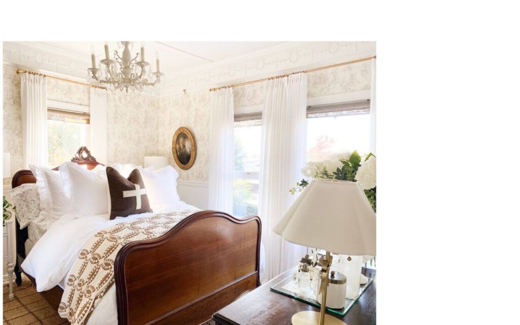 Cozy cottage bedroom with winter quilt layered on white bedding.