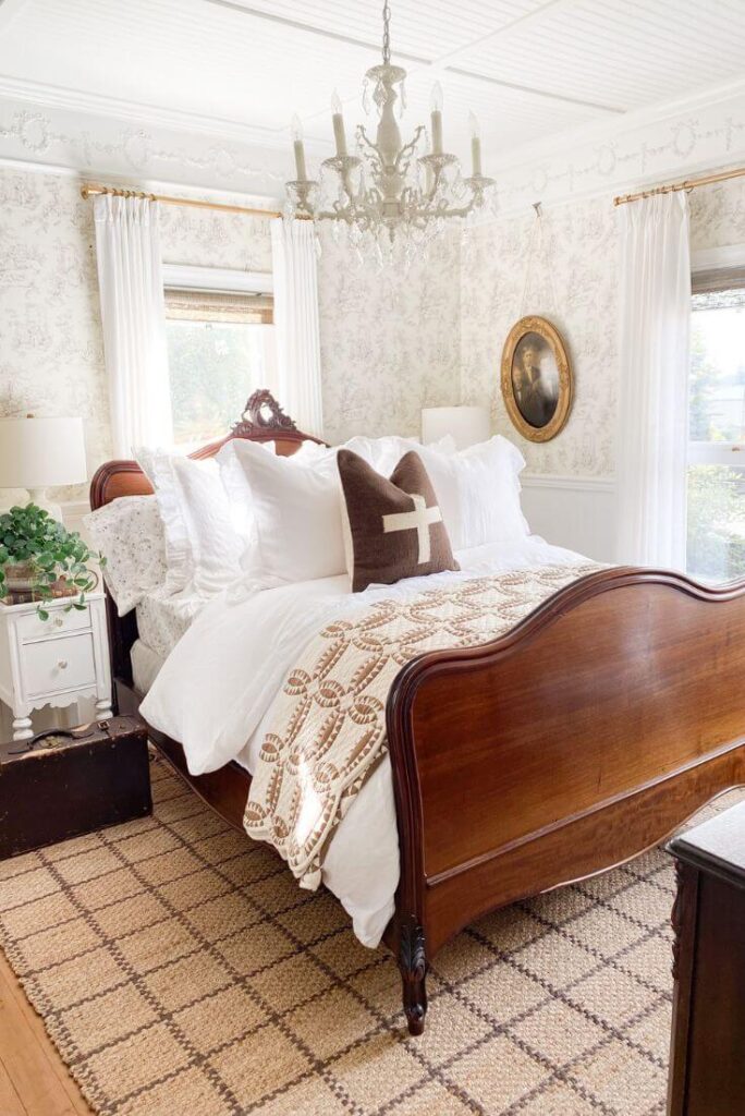 White bedding with winter quilt folded at the foot of the bed.