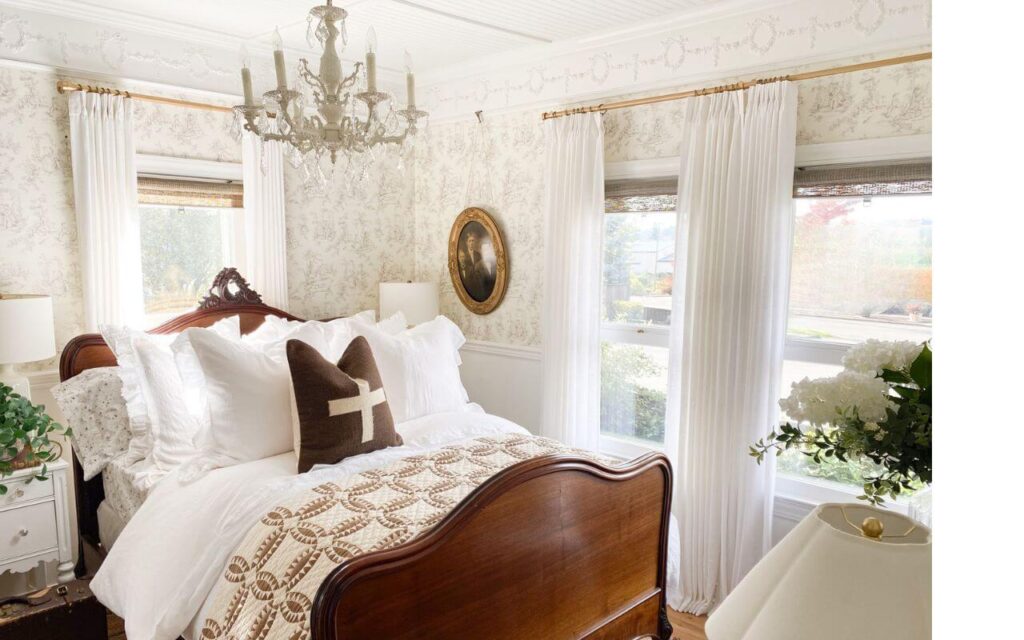 Pottery Barn quilt displayed on an antique wood bed.