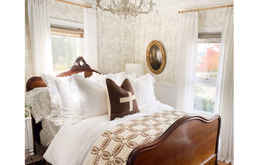 Close-up of winter bedding layers in a cozy cottage bedroom.
