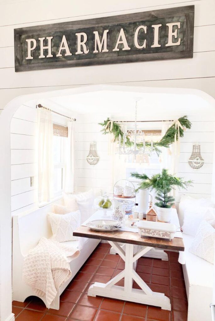 Christmas kitchen table setting with cake plate and transferware dishes.