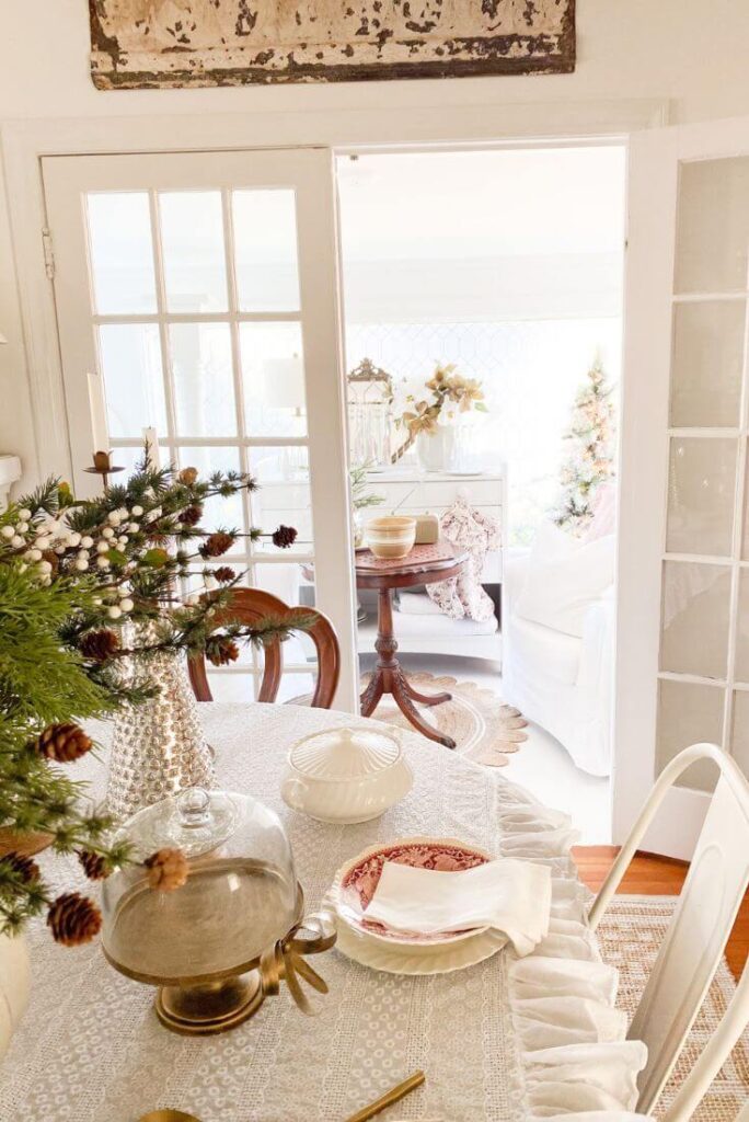 Vintage red transferware plates displayed on a Christmas dining table in a cozy, neutral dining room