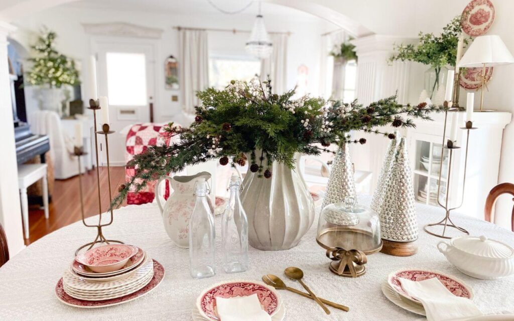 Soft, neutral Christmas dining room with a vintage table setting and subtle red accents