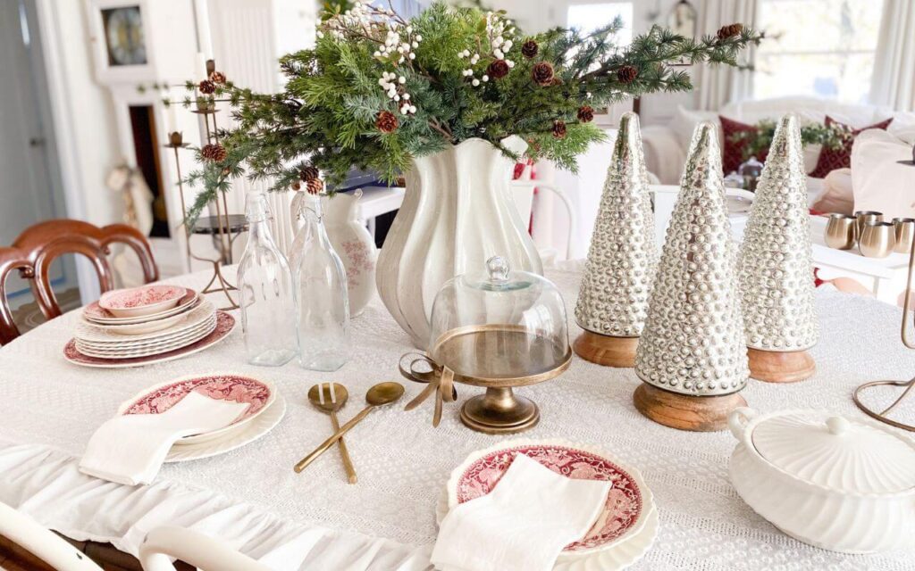 Cozy Christmas table decor featuring vintage red transferware dishes and classic cottage-style details