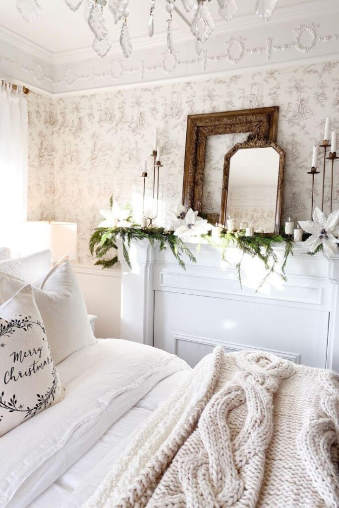 Wide view of the bedroom mantel featuring clip-on candles, winter greenery, and antique gold frames arranged for Christmas.