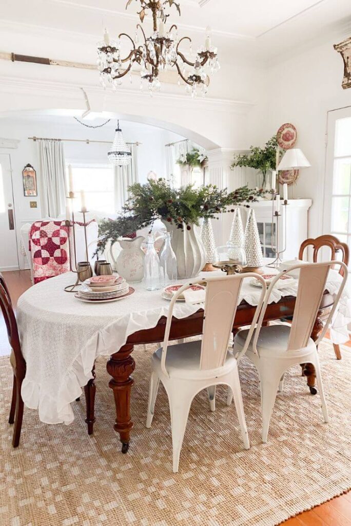 Neutral Christmas dining room with a simple holiday table featuring vintage red transferware and mercury glass trees