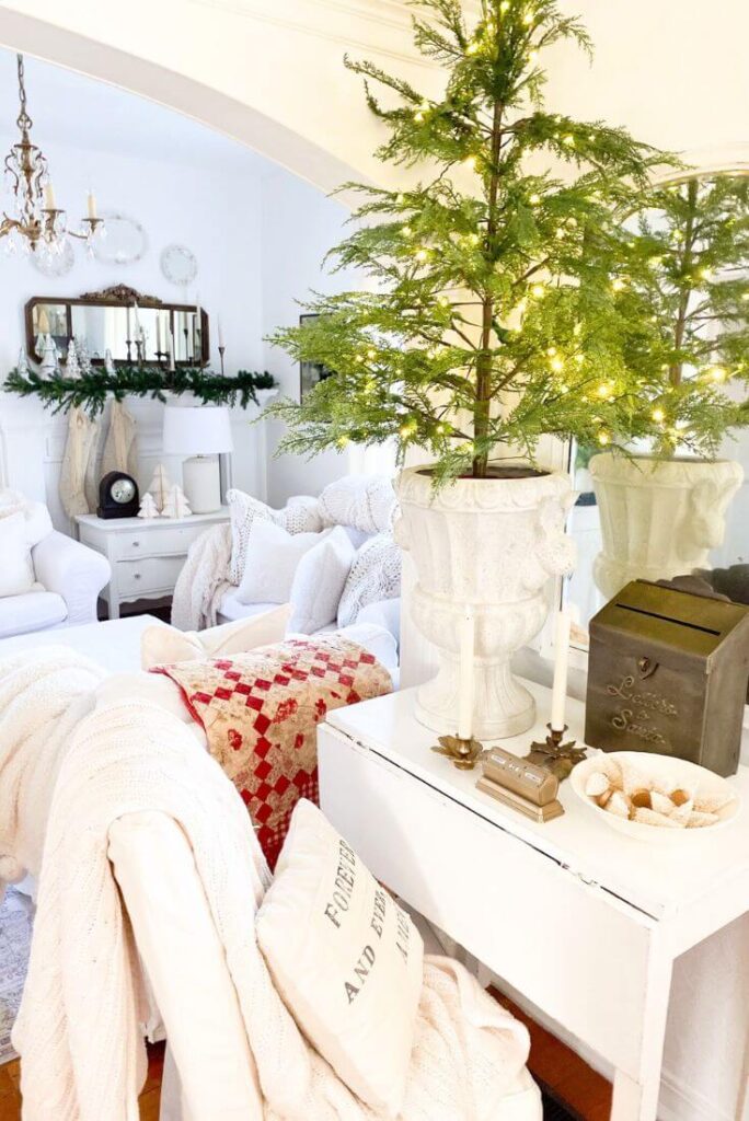 Antique mirror and small table styled with classic holiday pieces and cozy cottage Christmas decor.