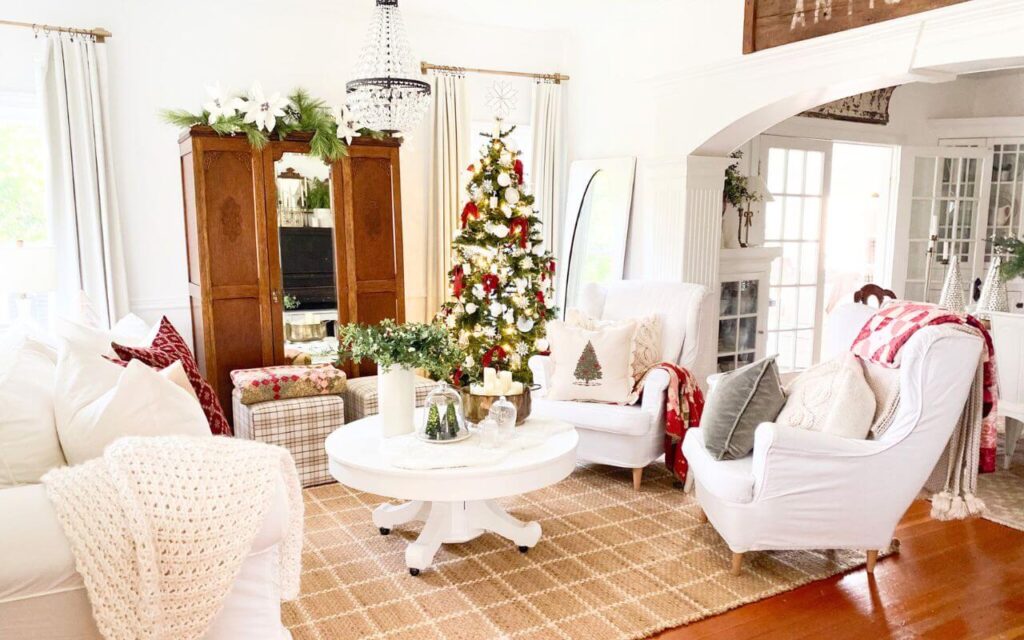 Neutral living room with red pillow covers and classic holiday styling.