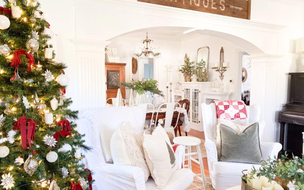 Living room at Christmas time with vintage style quilts draped over chairs for a cozy, lived-in look