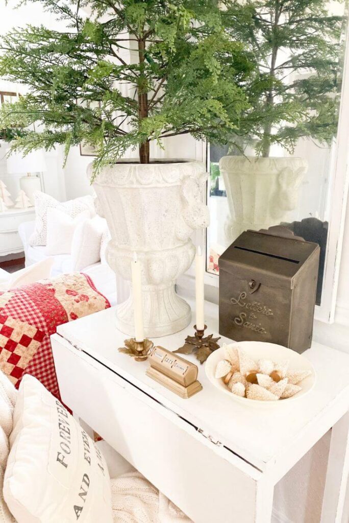 Entry table decorated with a “Letters to Santa” box, greenery, and classic cottage Christmas pieces.