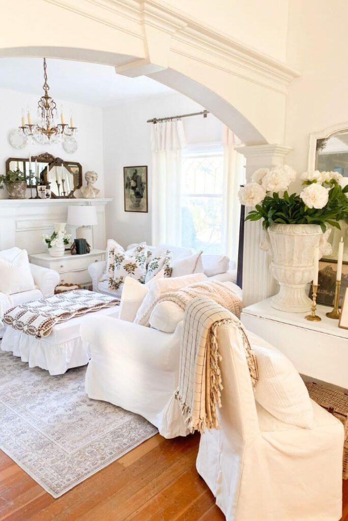 Cozy winter-to-spring living room refresh with layered pillows, quilts, and soft neutral tones