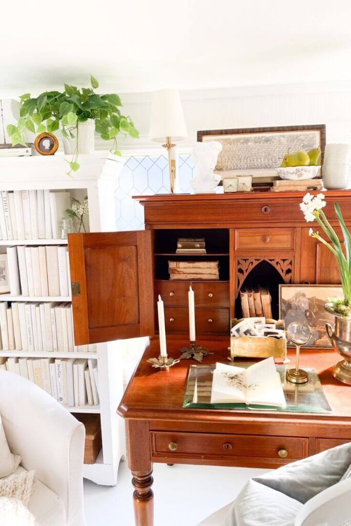 Collected books and antiques displayed in a compact home workspace