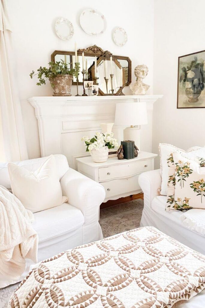 Pre-spring living room decor featuring a cozy seating area with quilts, throws, and soft neutral layers