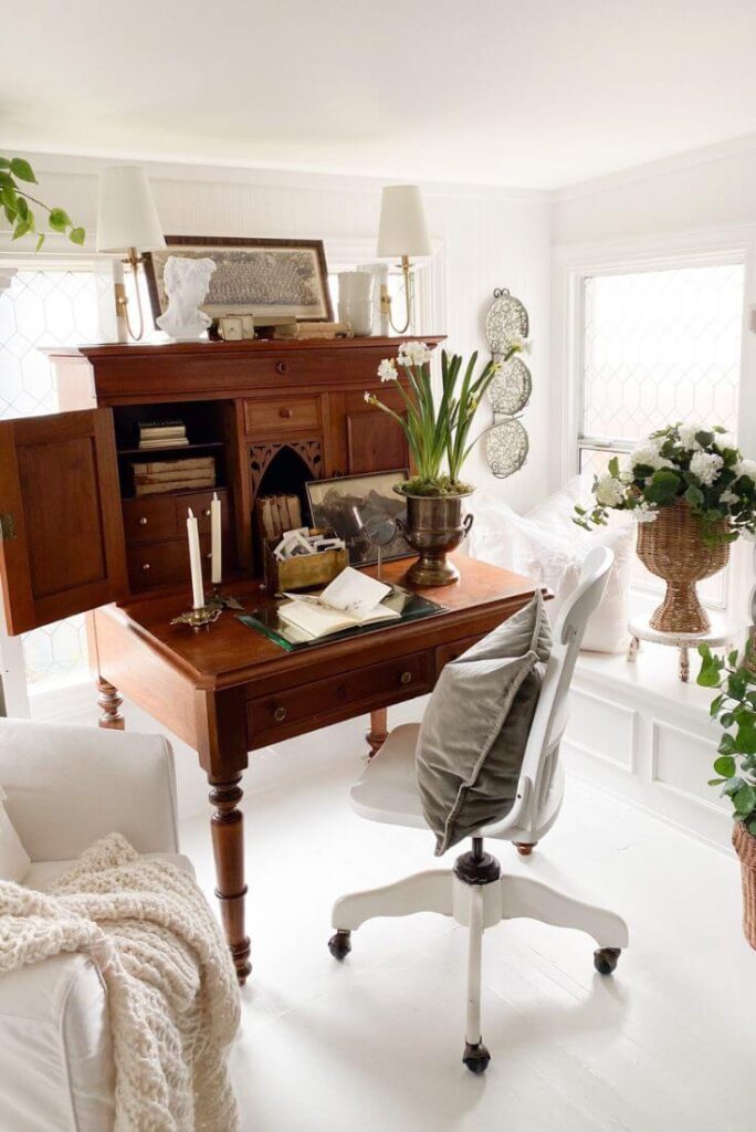 Textured beadboard wallpaper painted white in a sunroom workspace