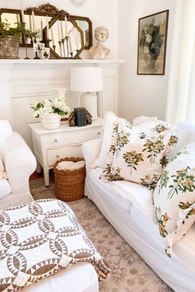 Living room styled for late winter with quilts, textured pillows, and subtle spring accents